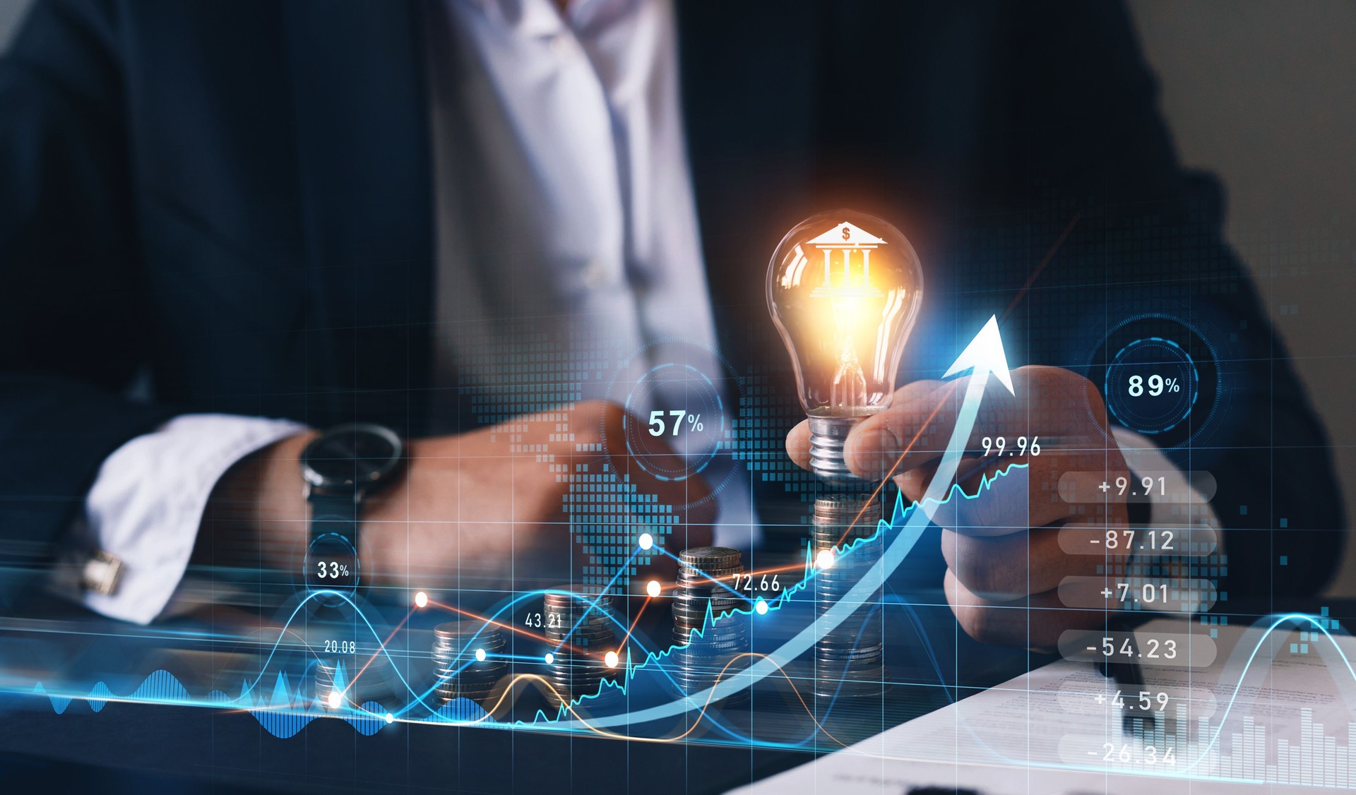 Businessman holding light bulb  with bank icon and sales data business growth graph. Financial innovation technology.